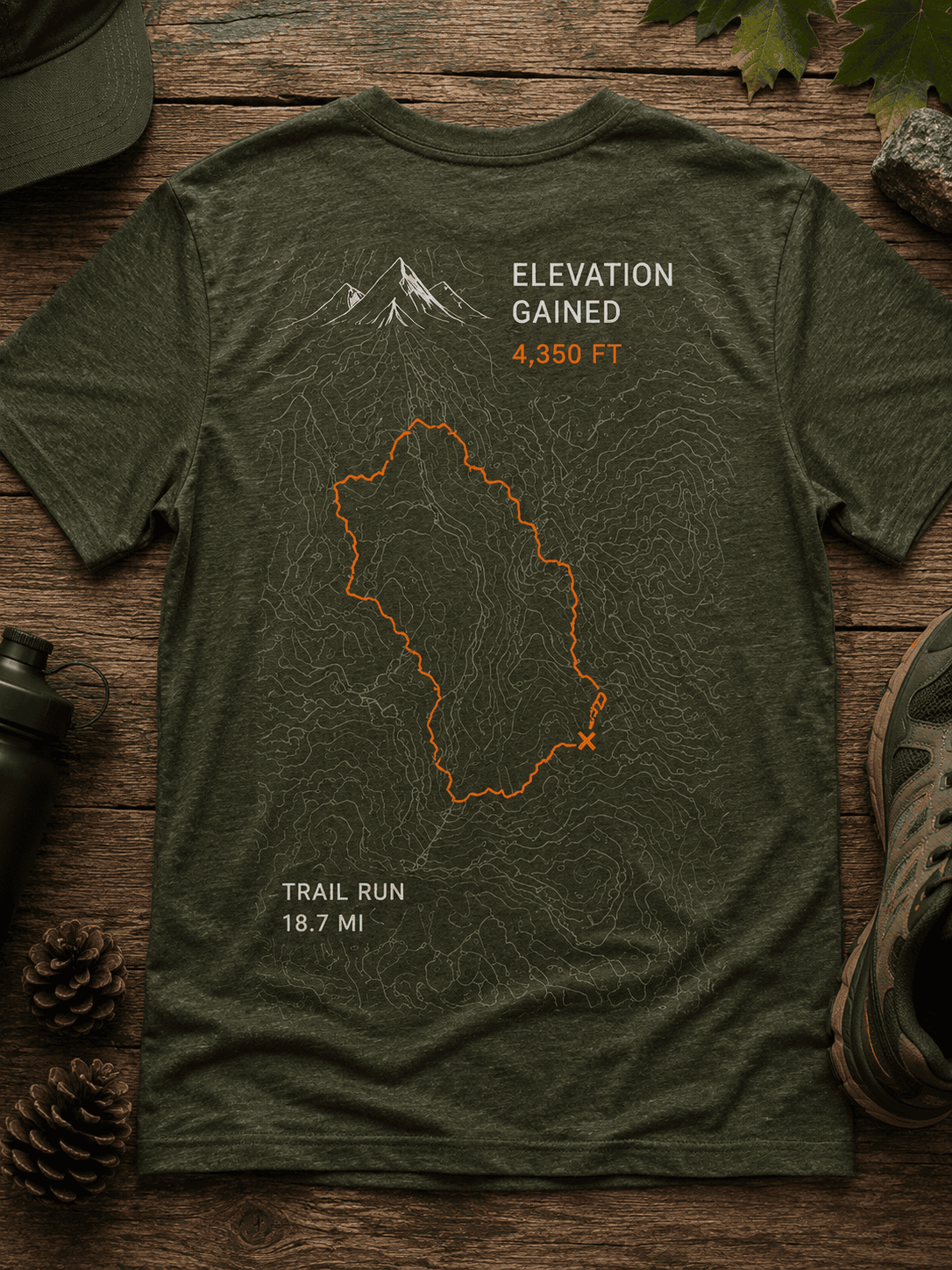 Trail run shirt with topo map, orange route line, and elevation stats on dark green cotton.
