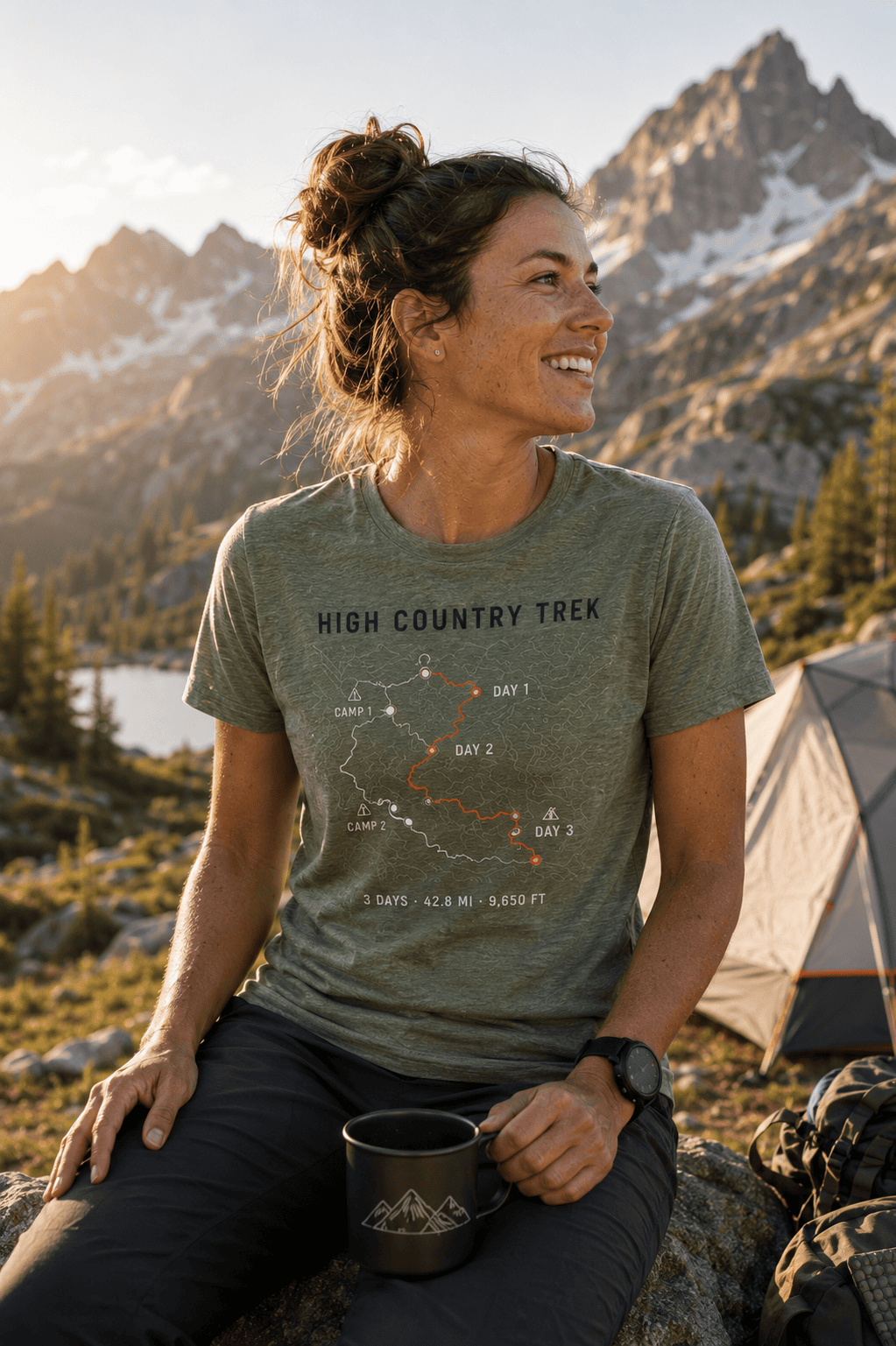 Woman at camp wearing a PacePrint High Country Trek multi-day route shirt.