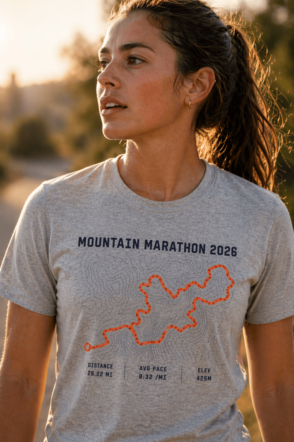 Woman wearing a PacePrint Mountain Marathon 2026 shirt with topo route and trail stats.